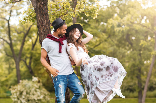 Couple standing and laughing outdoors - Фото, зображення