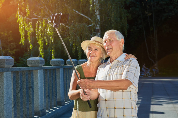 Old couple taking selfie outdoors. - Foto, Imagem