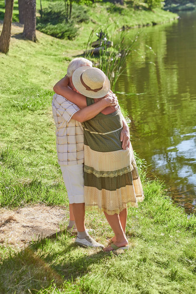 Senior couple hugging outdoors. - Zdjęcie, obraz