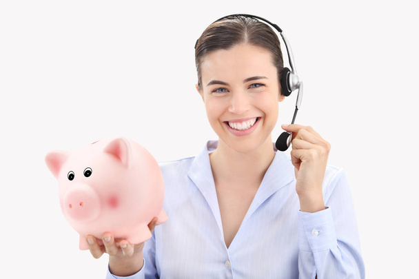 smiling woman with headset and piggy bank isolated on white back - Photo, Image