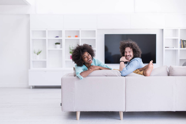 young multiethnic couple in living room - Photo, Image