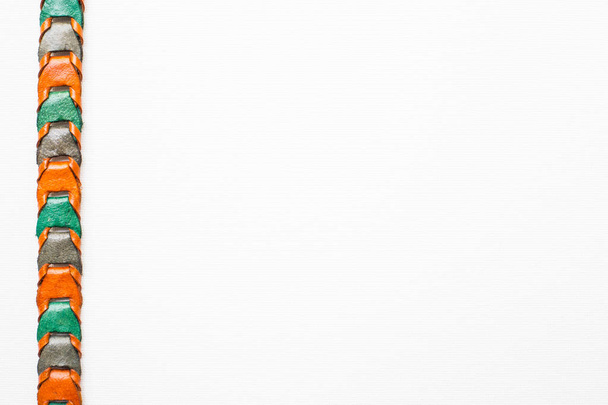 Leather knitted belt on white background - Fotó, kép