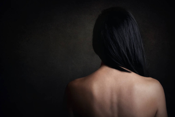 Sexy woman with bare back on black background - Fotó, kép