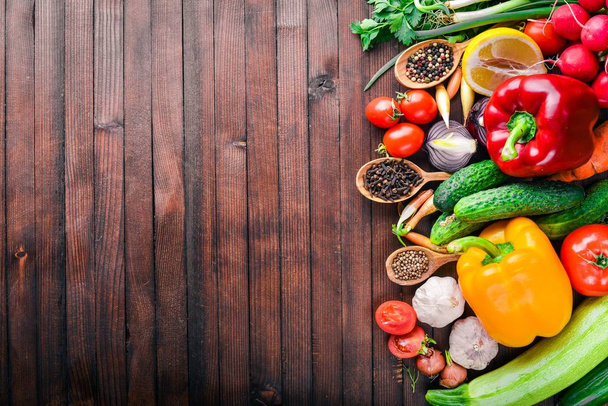 Frame of organic food. Fresh raw vegetables and spices. On a wooden chalkboard. - Фото, зображення