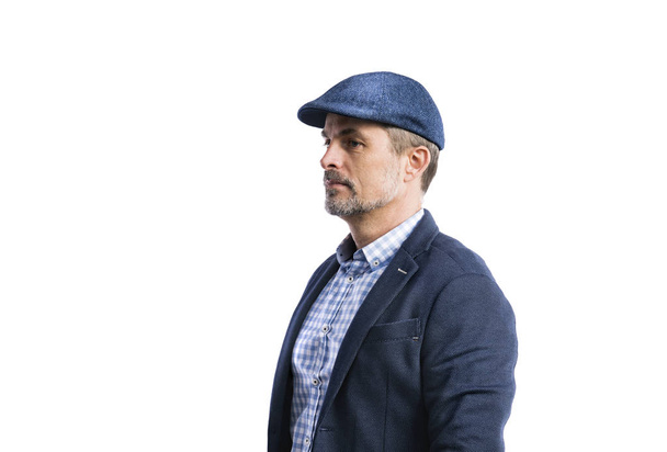 Mature hipster man in shirt, jacket and hat. Studio shot, isolat - Фото, изображение