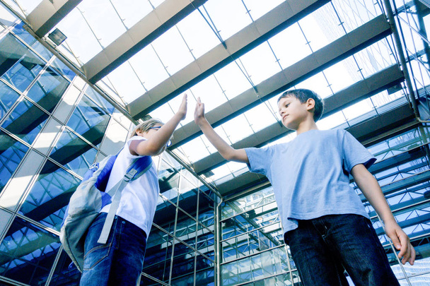 Two boys giving each other a high five outdoors - Photo, Image
