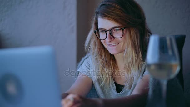 Cute blonde woman in glasses chat online on laptop - Imágenes, Vídeo