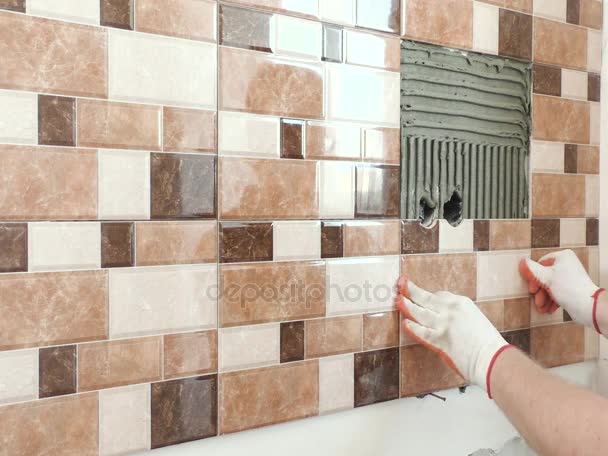 The tiler's hands are installing a tile. - Footage, Video