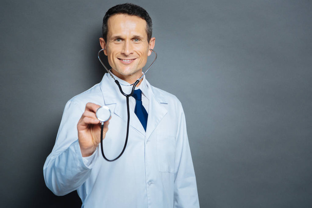 Friendly physician posing with stethoscope - Фото, зображення