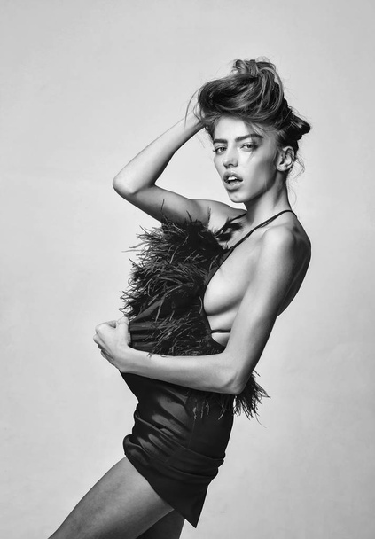 fashion model girl in dress with feather - Zdjęcie, obraz