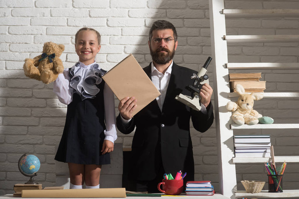 Schoolgirl and dad with happy and serious faces - Φωτογραφία, εικόνα