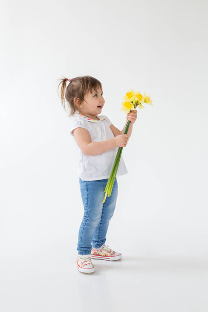 Little girl standing isolated over white background. - Photo, image