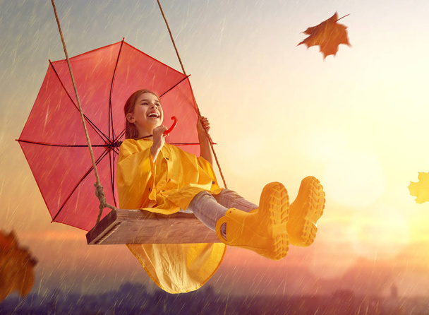 child with red umbrella - Фото, зображення