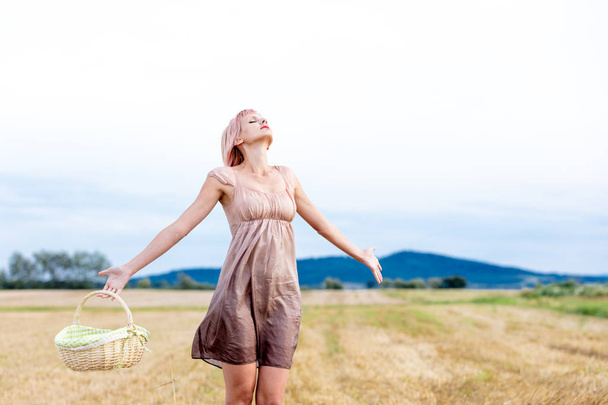 Woman with basket at field - Photo, Image