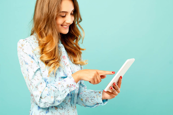 Portrait of a beautiful happy young woman with tablet - 写真・画像
