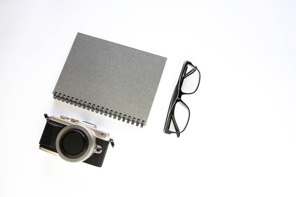 Notebook ,camera and glasses on white background. - Photo, image