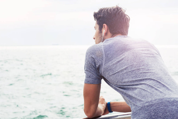 Sports man looking at sea outdoors - Photo, Image