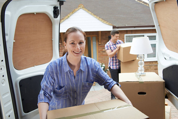Young Couple Moving In To New Home Unloading Removal Van - Photo, Image