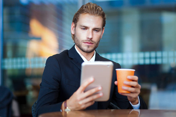 Handsome businessman enjoying coffee  - Фото, изображение