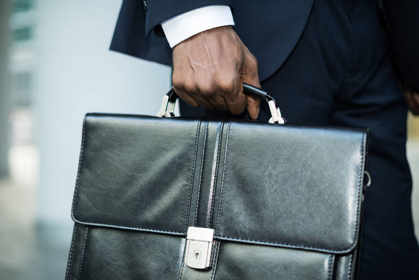 Businessman holding his briefcase - Фото, изображение