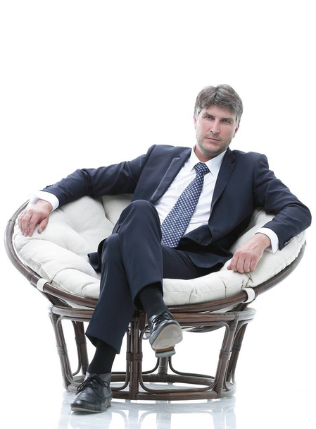 Tired business man sitting in a large comfortable chair - Φωτογραφία, εικόνα