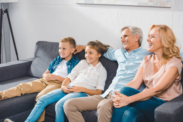happy family sitting on sofa - Φωτογραφία, εικόνα
