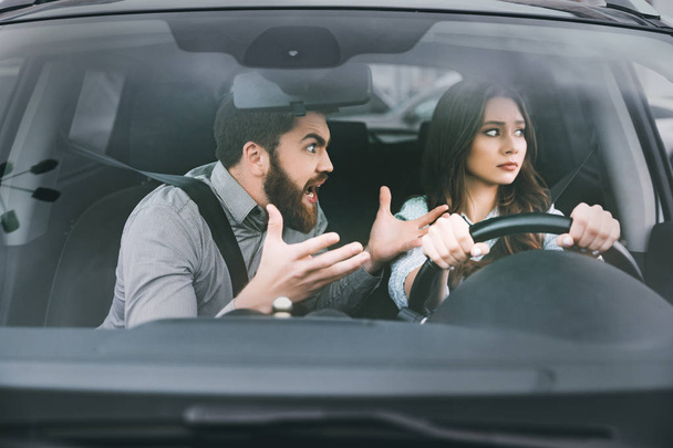 Unhappy woman and man in car - Фото, зображення
