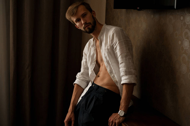 Young man in white unbuttoned shirt. - Photo, Image