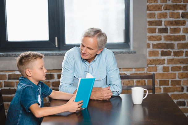  grandfather and grandson reading book  - Photo, image