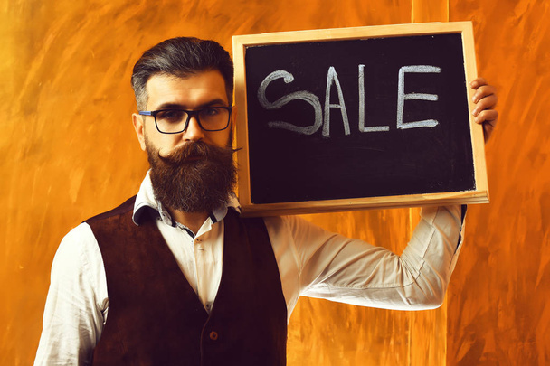 Bearded man, brutal caucasian hipster holding sale inscription o - Valokuva, kuva