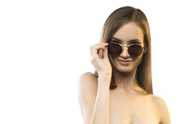 The beautiful girl with naked shoulders in sunglasses - Φωτογραφία, εικόνα