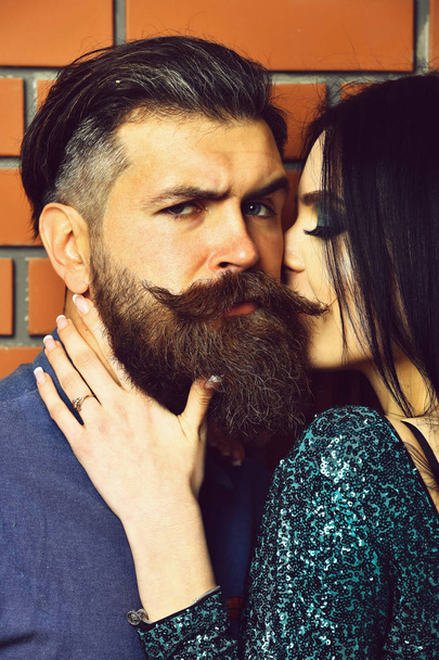 bearded man and pretty sexy woman on brick wall - Фото, зображення