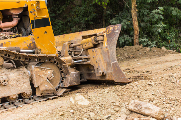 Escavadeira retroescavadeira carregador de equipamentos pesados veículo na estrada de construção dever
 - Foto, Imagem