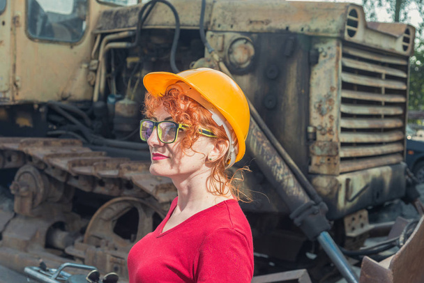Woman is an engineer. Woman in a construction helmet - Fotó, kép