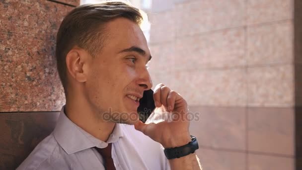 Young man checks his phone standing on the street - Video, Çekim