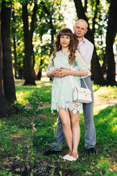 Beautiful young couple on the park background - Fotografie, Obrázek