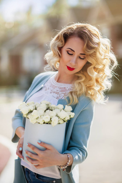 Beautiful woman with paper box of flowers - Fotoğraf, Görsel