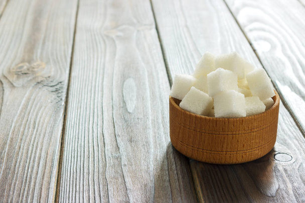 White sugar in bowls on wooden background. Selective focus, horizontal. - Photo, Image