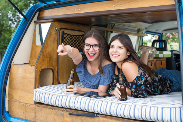 Mujeres jóvenes viajando en minivan
 - Foto, imagen