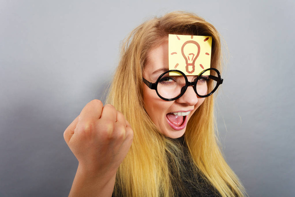 Woman having light bulb mark on forehead thinking - Photo, Image
