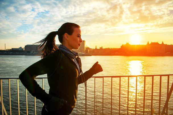 Young woman running in sunset	 - Photo, Image