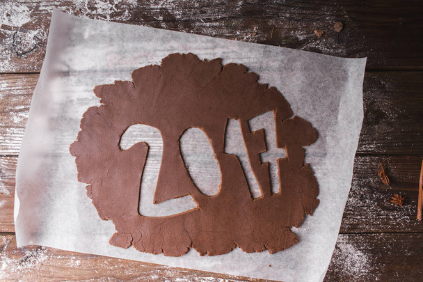 Christmas background. 2017 written with Chocolate dough on a wooden background - Photo, Image