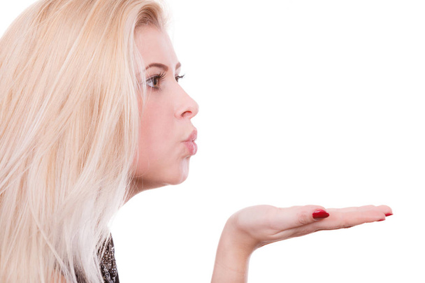 Blonde woman sending air kiss on palm hand - Foto, afbeelding