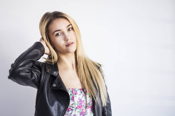 beautiful young blonde woman in nice spring dress with leather jackets - Photo, Image