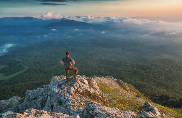 Man standing on a rocky mountain top - Foto, Bild