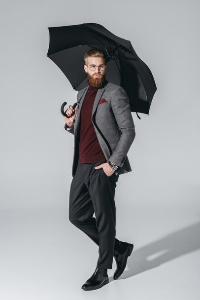 attractive young man with umbrella - 写真・画像