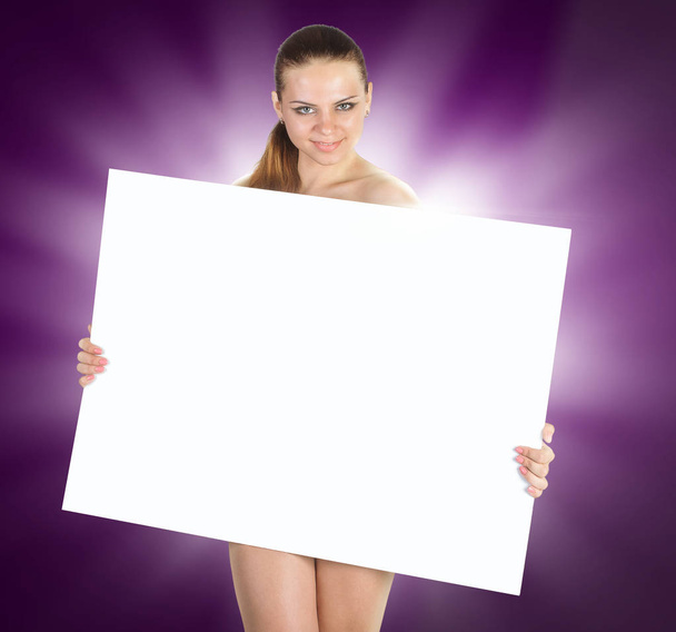 Beautiful young woman with a white empty blank pose in the studi - Valokuva, kuva