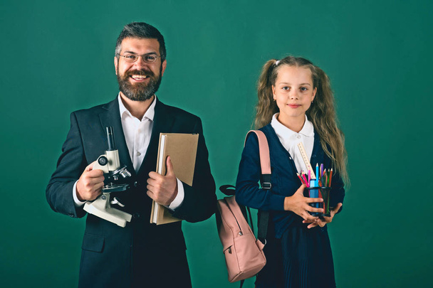 Girl and man in suit and school uniform - Foto, imagen