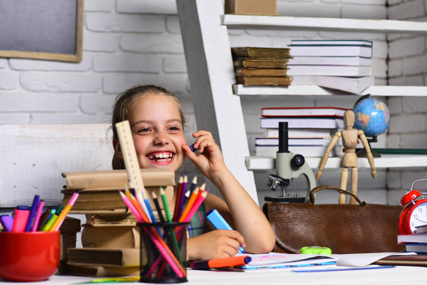 Kid and school supplies on classroom background - Photo, Image