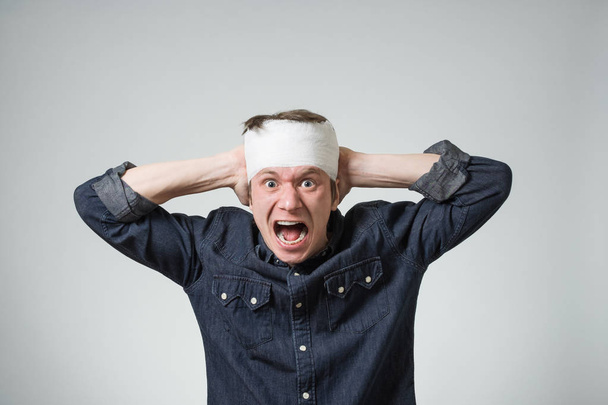 Man with bandage on his head - Fotó, kép